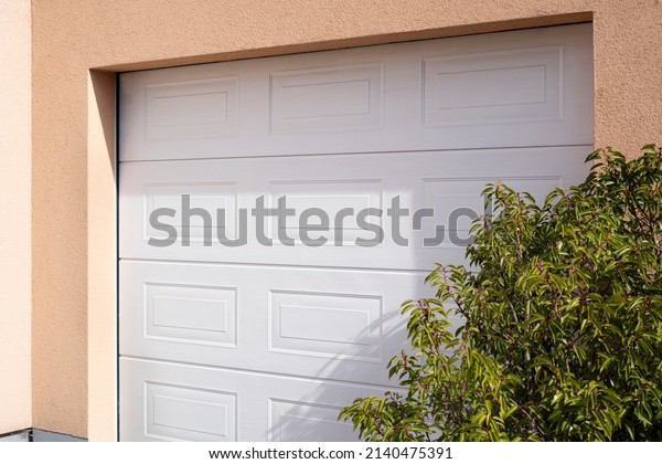 closeup of a\
white electric garage sectional\
door