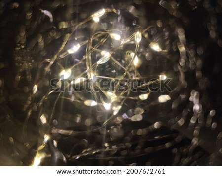 Close-up of the white fairy lights inside a globe. Selective focus points with bokeh effect.