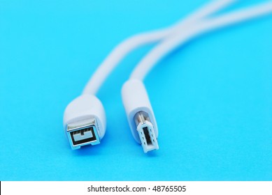Closeup of white firewire cable on blue