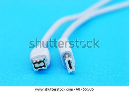 Closeup of white firewire cable on blue