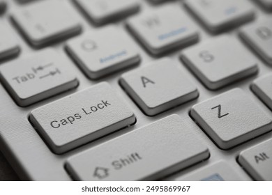 Close-Up of a White Keyboard's Caps Lock Key with Alphabetic Keys