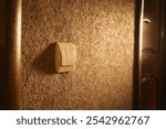 Close-up of a white light switch in sunlight. High quality photo