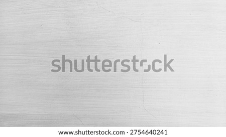 Close-up of a white painted wall with subtle brush stroke textures and a faint hairline crack.
