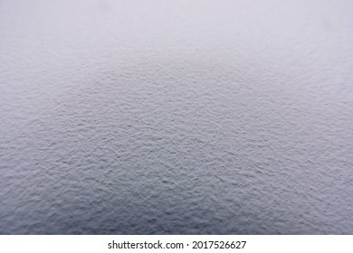 A close-up of a white painted wall surface