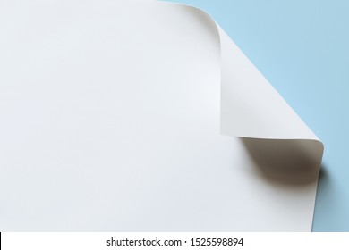 Close-up of white paper with bent corner, texture background