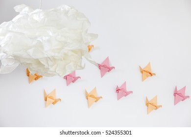 Close-up of white paper lamp and origami paper decoration on the wall