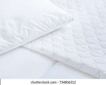 Closeup Of White Pillow Cover Sheet And Topper Bed.