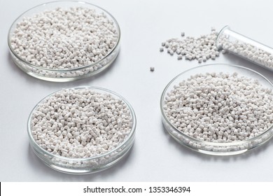 A Closeup Of A White Plastic Resin In Granules In A Chemical Laboratory. Industrial Or Scientific Background.