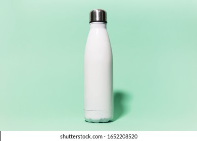 Close-up Of White Reusable Steel Stainless Thermo Water Bottle Isolated On Background Of Aqua Menthe Color. Plastic Free.