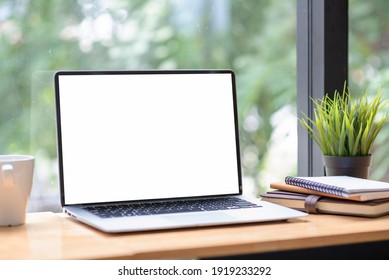 Close-up of a white screen laptop placed at the office. Mock up. - Powered by Shutterstock