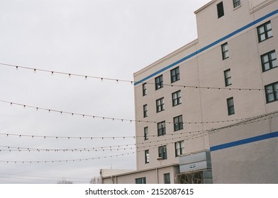 A Closeup Of A White Stone Building Facade Against A Cloudy Sky