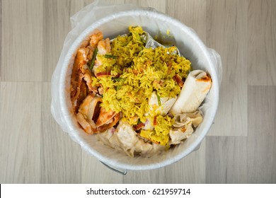 Close-up Of White Trash Bin Covered With Leftover Food