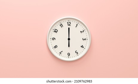 Closeup white wall clock set on light pink background.  White wall clock hanging on the wall. Minimalist flat lay image of plastic wall clock over pink background. Copy space and central composition.