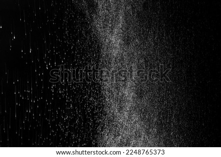 Close-up of white water vapor with water splashes flying in different directions from the humidifier Isolated on a black background. White fantasy steam to overlay on your photos