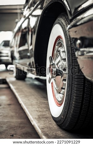 Close-up of a whitewall tire and chrome rim of a vintage us car