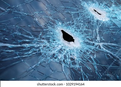 Closeup Of A Whole And Cracked Windshield Produced By Gunshots