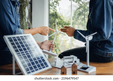 Close-up at windmill, Engineers pointing at wind turbines with their hands. To jointly design the use of renewable energy with wind and solar energy. Concept of using renewable energy. - Powered by Shutterstock