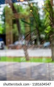 .Close-up Of A Window With A Reflection Of The Street And A Cafe Outside The Window