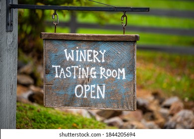 Closeup of Winery Tasting Room Open sign with bokeh background of grape vineyard winery farm landscape - Shutterstock ID 1844205694