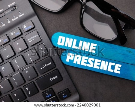 A closeup of wireless keyboard and glasses with the word ONLINE PRESENCE - Business concept