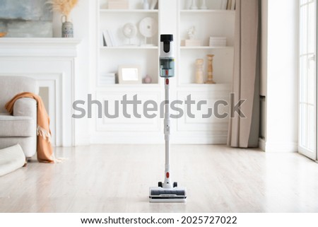 Close-up of wireless modern vacuum cleaner in light interior. House cleaning. Сток-фото © 