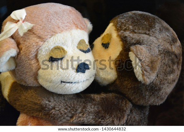 hugging stuffed monkeys