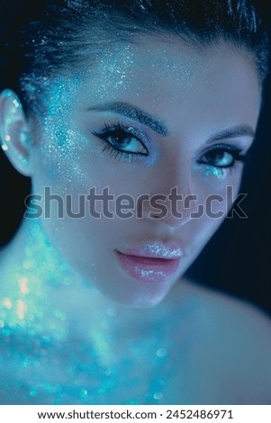Close-up of a woman adorned with glittering makeup, resembling a starry night sky