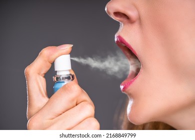 Close-up Of A Woman Applying Fresh Breath Spray