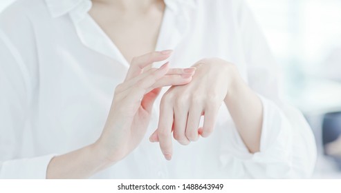 Closeup Of Woman Applying Lotion On Hand In The Morining