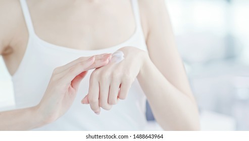 Closeup Of Woman Applying Lotion On Hand In The Morining