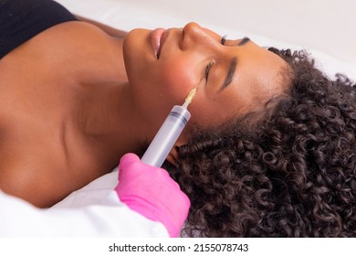 Closeup Of Woman Applying Ozone To Her Face For Cosmetic Treatment.