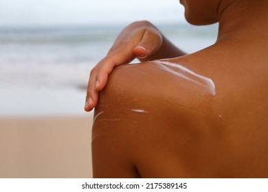 Closeup Woman Applying Sunblock Cream Lotion On Beach For Broad Spectrum UVA, UVB Sun Protection