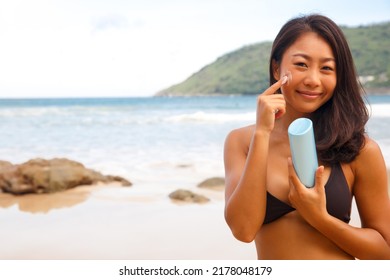 Closeup Woman Applying Sunblock Cream Lotion On Beach For Broad Spectrum UVA, UVB Sun Protection