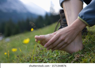 Close-up Of Woman With Band Aid On Toe After Hiking