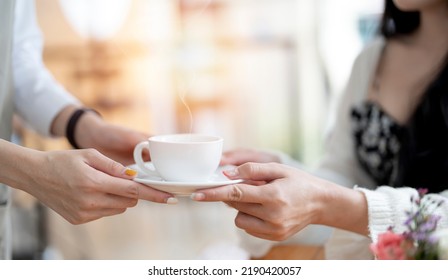 Closeup of woman barista serving cup of coffee to customer. Job and occupation. Food and drink beverage. Coffee shop and Cafe. Business and restaurant ownership - Powered by Shutterstock