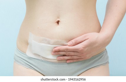 Closeup of woman belly with scar from cesarean section with a medical bandage.Suture after surgery.Consequences after cesarean section for woman.Care of the suture after the birth of the child - Shutterstock ID 1943162956