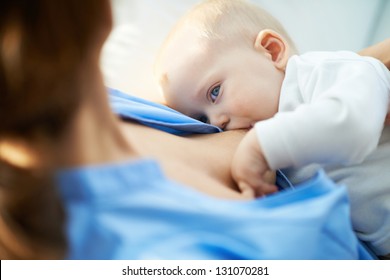 Close-up of woman breastfeeding her small son