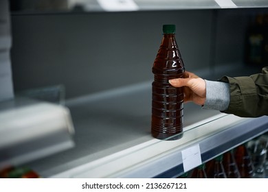 Close-up Of Woman Buying Last Bottle Of Cooking Oil In Grocery Store. 