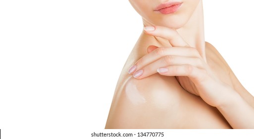 Close-up of a woman cares about her shoulder applying cosmetic cream. Isolated on white background