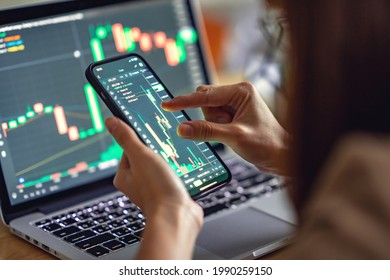 Closeup - Woman is checking Bitcoin price chart on digital exchange on smartphone, cryptocurrency future price action prediction. - Shutterstock ID 1990259150