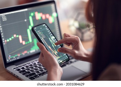 Closeup - Woman is checking Bitcoin price chart on digital exchange on smartphone, cryptocurrency future price action prediction. - Shutterstock ID 2031084629