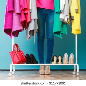 Closeup Of Woman Choosing Clothes To Wear In Wardrobe. Girl Customer Shopping In Mall Shop. Fashion Clothing Sale Concept.