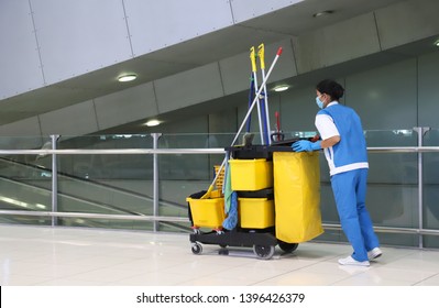 Closeup of woman cleaning worker doing her work with janitorial, cleaning equipment and tools for floor cleaning at the airport.