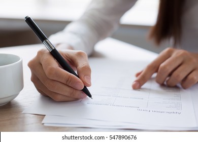 Closeup of Woman Completing Application Form - Shutterstock ID 547890676