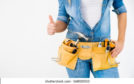 Close-up Woman Construction Worker Wearing Tool Belt Showing Thumbs Up On White