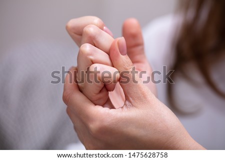 Close-up Of Woman Cracking Their Knuckles At Home