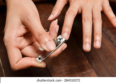 Closeup Of A Woman Cutting Nails