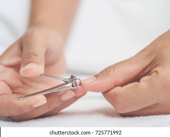 Closeup of a woman cutting nails, health care concept. - Shutterstock ID 725771992