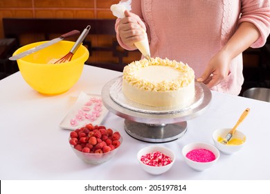 Close-up Of Woman Decorating Cake