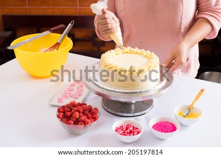 Close-up of woman decorating cake